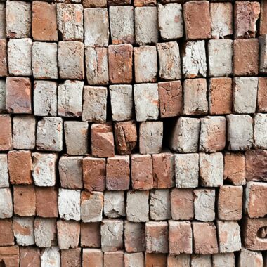 Detailed view of stacked red and white bricks showcasing natural texture and pattern.